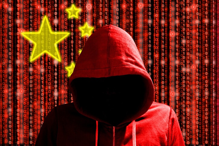 Chinese hacker in front of digital datastream flag